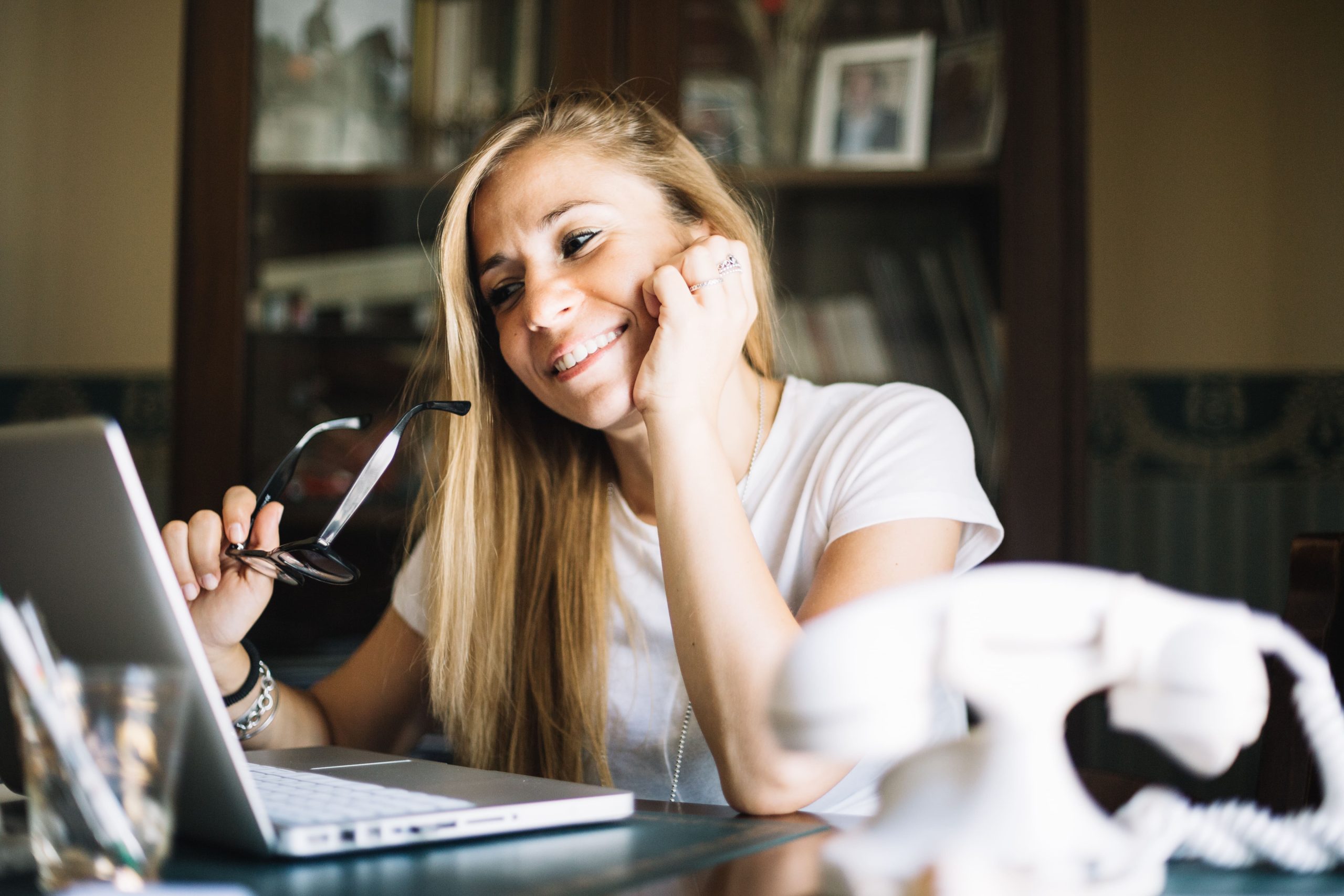 content-woman-watching-laptop-while-chatting-min